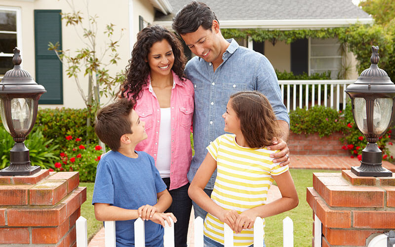 Happy family outside home